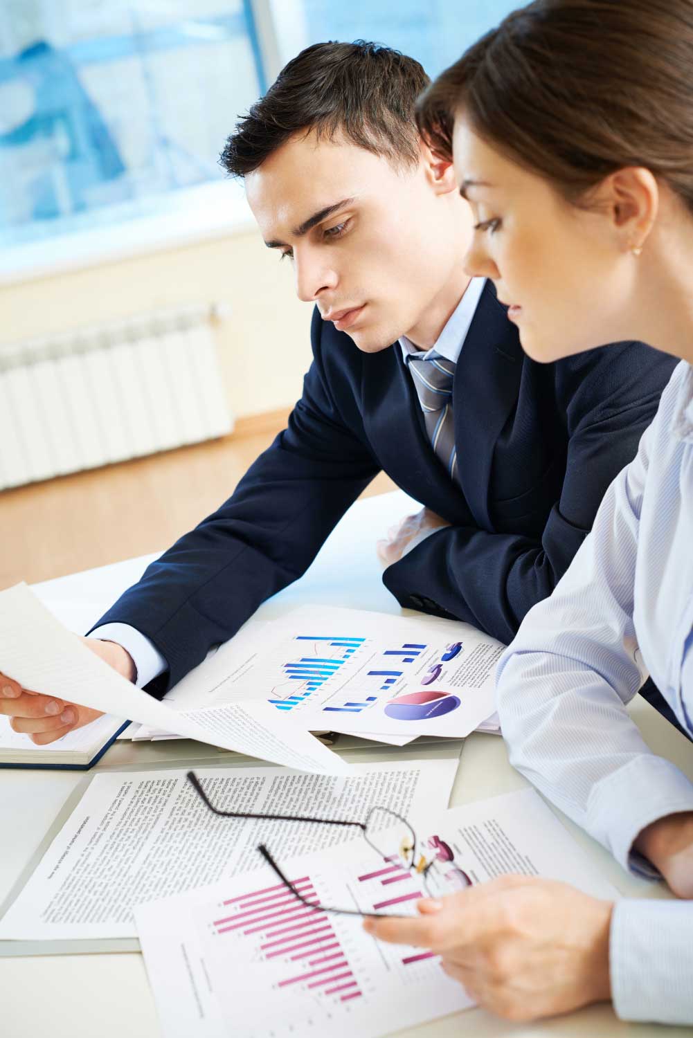 account-3 Business professionals reviewing financial statements and performance charts during consultation at a trusted CPA Miami FL accounting and financial services firm