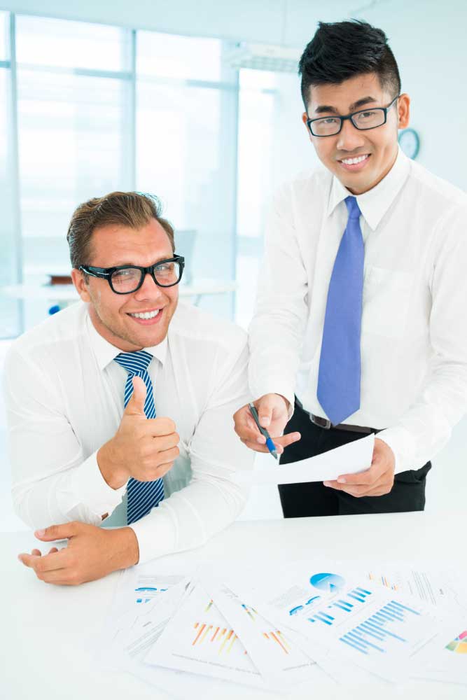 business-financial-consultant-1 Two accounting professionals reviewing financial reports together in a bright office, providing reliable bookkeeping services Fort Lauderdale for clients