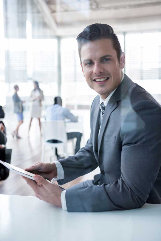 business-financial-consultant-4 Confident professional reviewing business data on a tablet in a modern office, offering expert business financial consultant Fort Lauderdale services