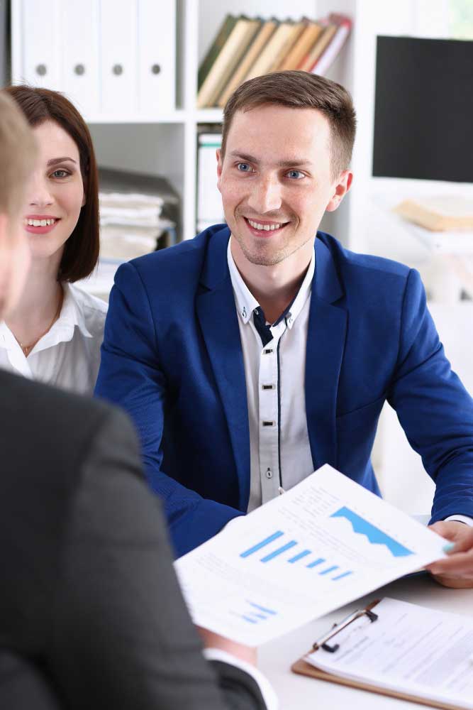 cpa-1 Smiling accounting professional presenting financial reports during a client meeting, showcasing expert cpa boca raton accounting services
