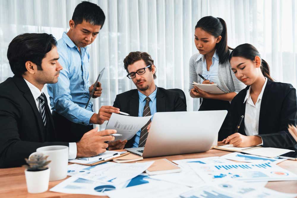 cpa-2 Professional accounting team reviewing financial documents and reports in an office meeting, providing reliable cpa boca raton services
