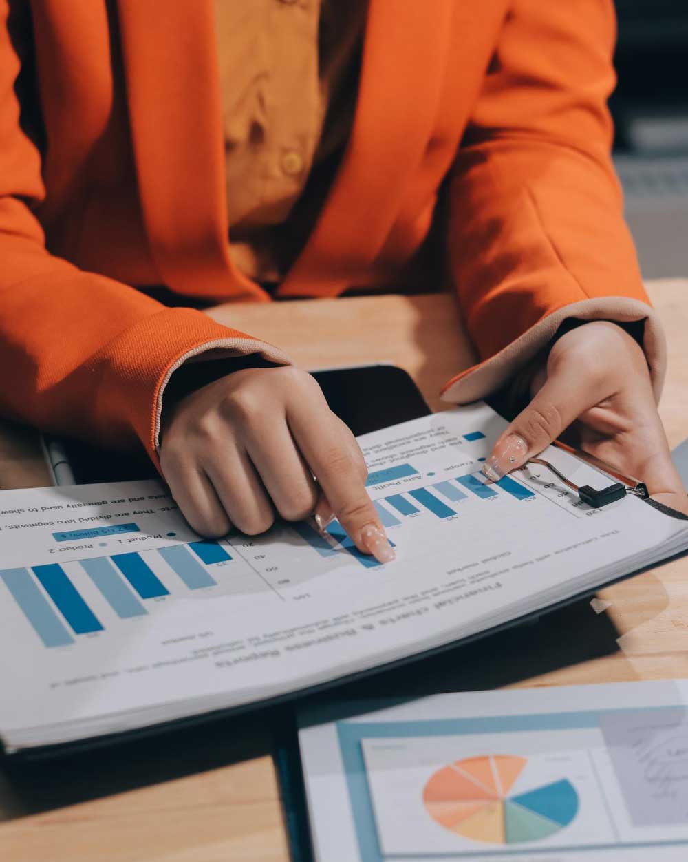 tax-refund-miami-3 Tax consultant reviewing financial charts and pointing to refund data on reports during Tax Refund Miami tax planning and refund services